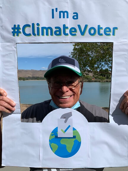 Photo of Abe holding climate voter sign