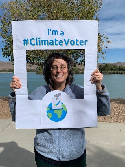 Photo of Councilmember Jenny Kassan holding climate voter sign