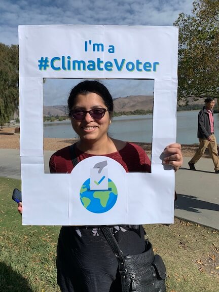 Photo of one of the parents holding climate voter sign